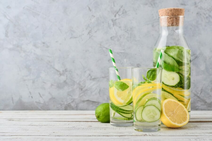 Be So Well - 2 glasses filled with Lime, cucumber, and Lemon Water